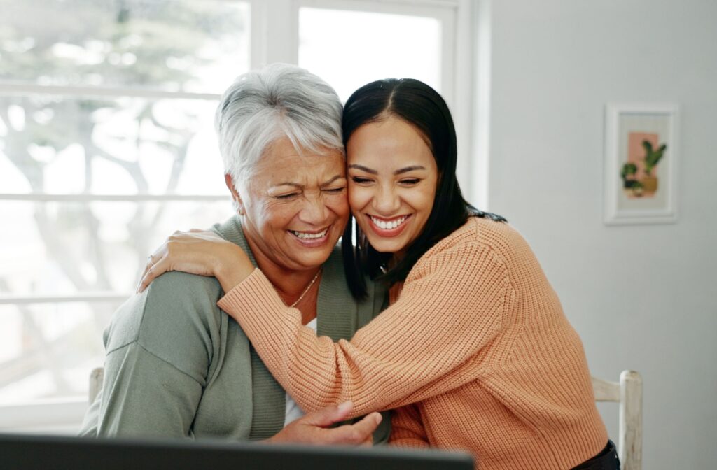 An older person and their child in an embrace after chatting about asking for help.