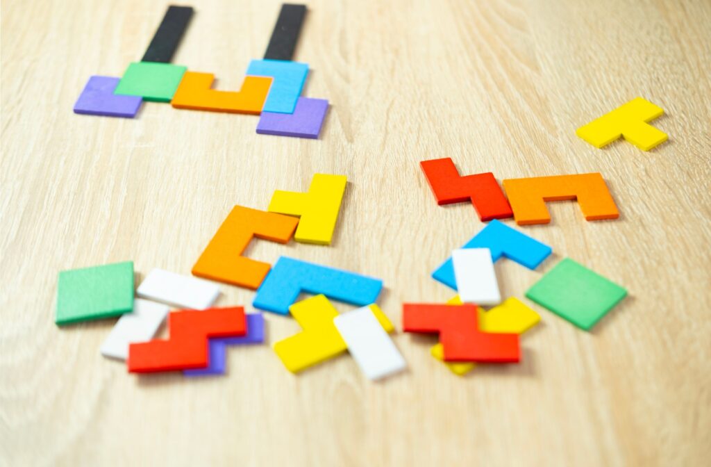 A colorful wooden geometric puzzle lies in pieces, representing dementia.